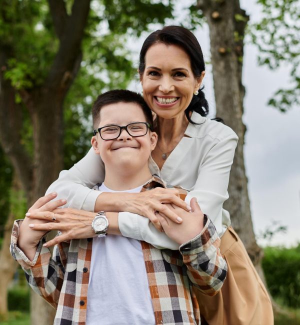 mother-and-son-embrace-in-park-2026-03-12-22-41-01-utc